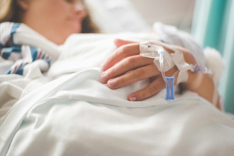 Woman lying in hospital bed