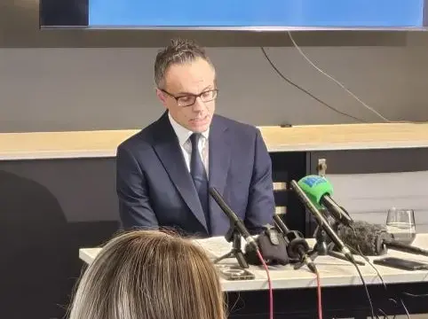 Greg Almond briefs the media
