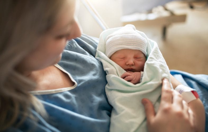 Mother with her newborn baby at the hospital a day after a natural birth labor