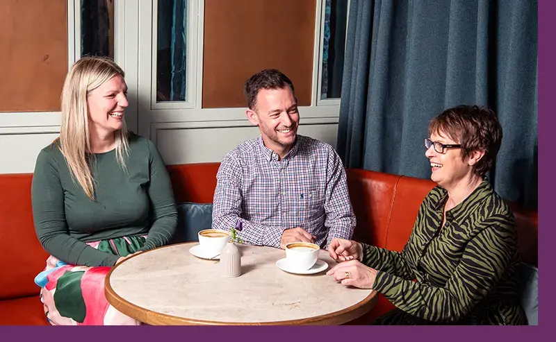 Solicitors share coffee with a client